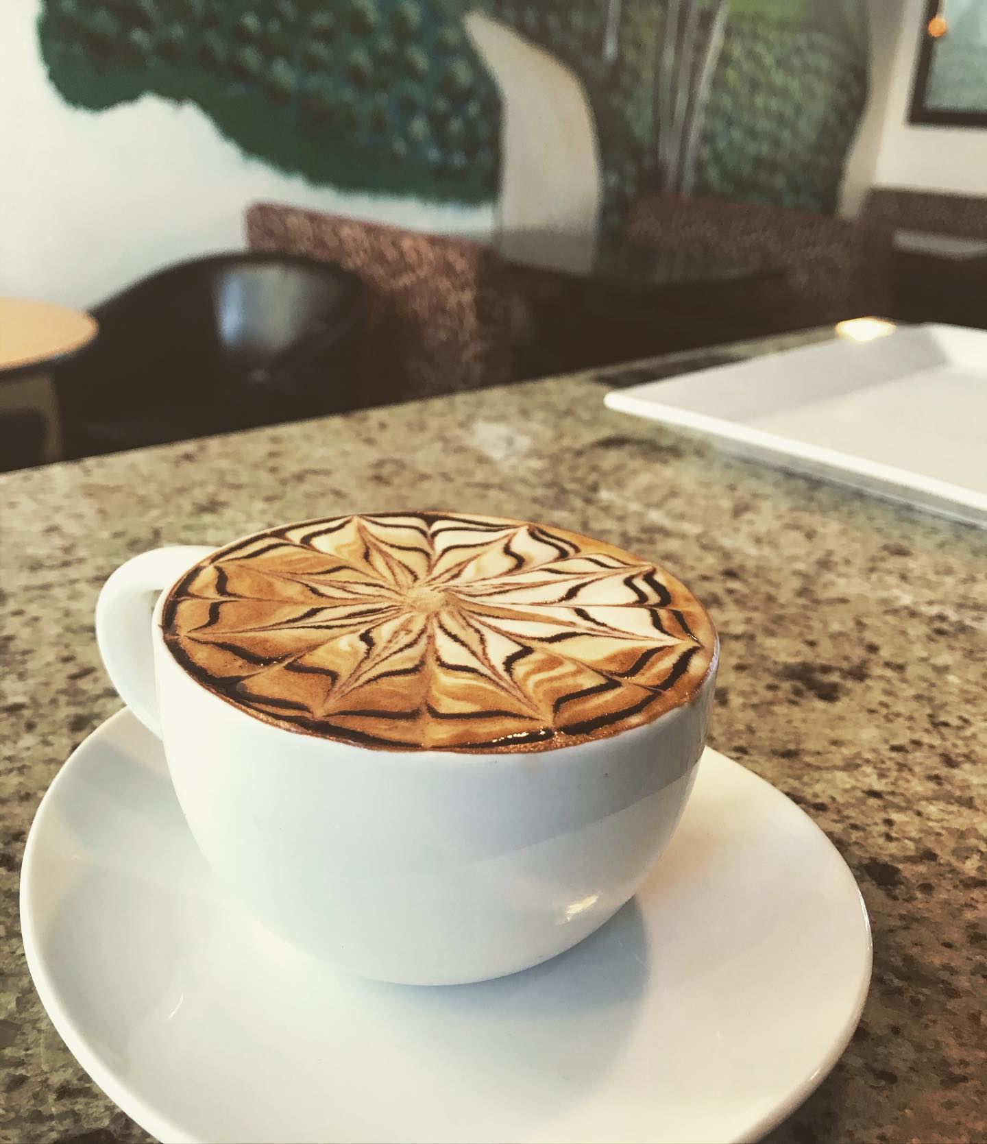 An artfully crafted latte with a flower design made with Francy's gourmet coffee.